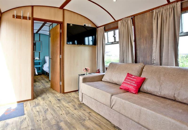 The living area in Brunel Boutique Railway Carriage 5 at Brunel Boutique Holiday Park in Dawlish Warren, South Devon