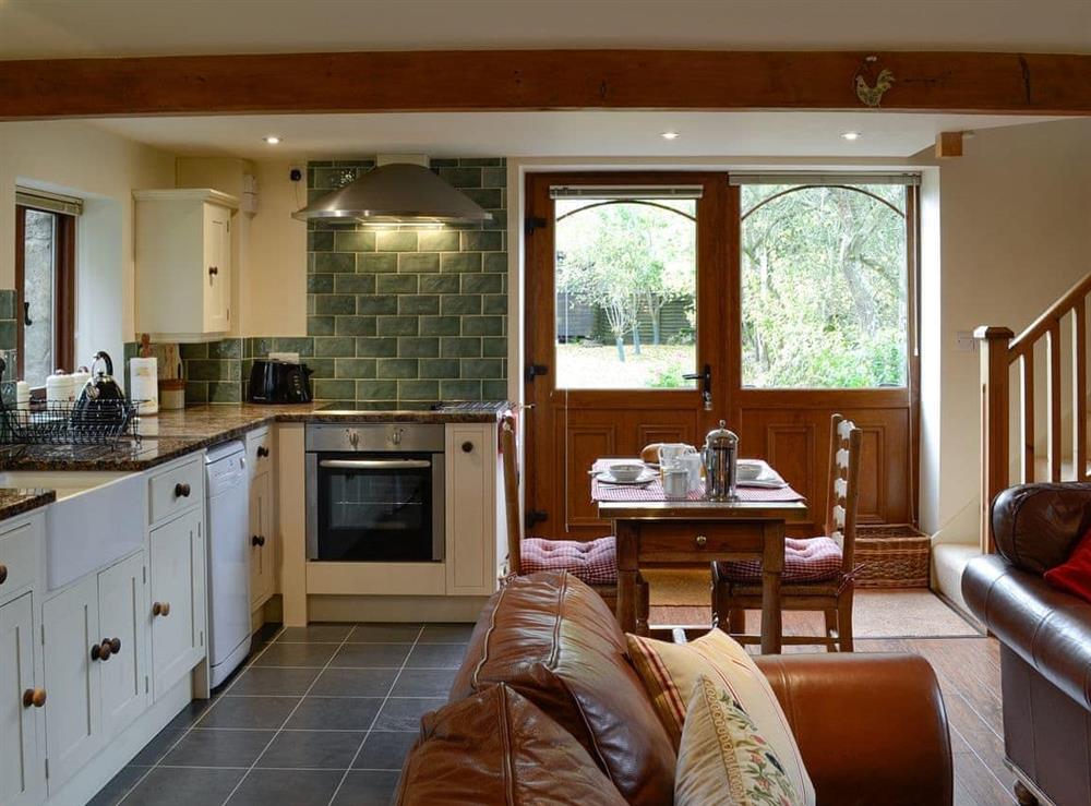 Kitchen with dining area at Bryn Dedwydd Cottage in Eryrys, near Mold, Clwyd