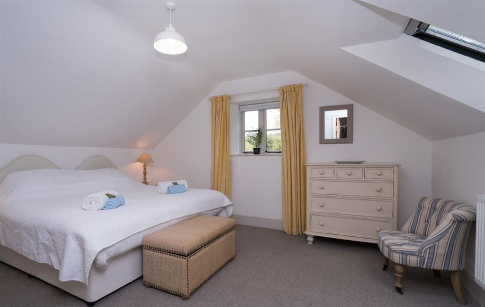 Double bedroom with 5’ king size bed and en-suite shower room at Bryn Derw, Bodnant Estate