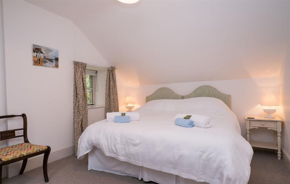 Double bedroom with 6’ king size zip and link beds and en-suite bathroom at Bryn Derw, Bodnant Estate