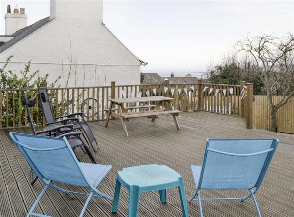 Decked patio area with outdoor furniture at Bryn Euryn Cottage in Rhos-on-Sea, near Colwyn Bay, Conwy