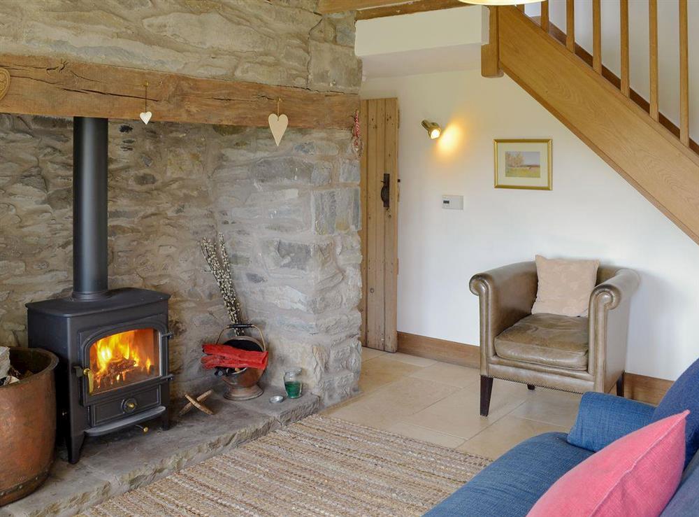 Homely living area with wood burner at Bryn Gwnog in Llanrwst, near Betws-y-Coed, Gwynedd