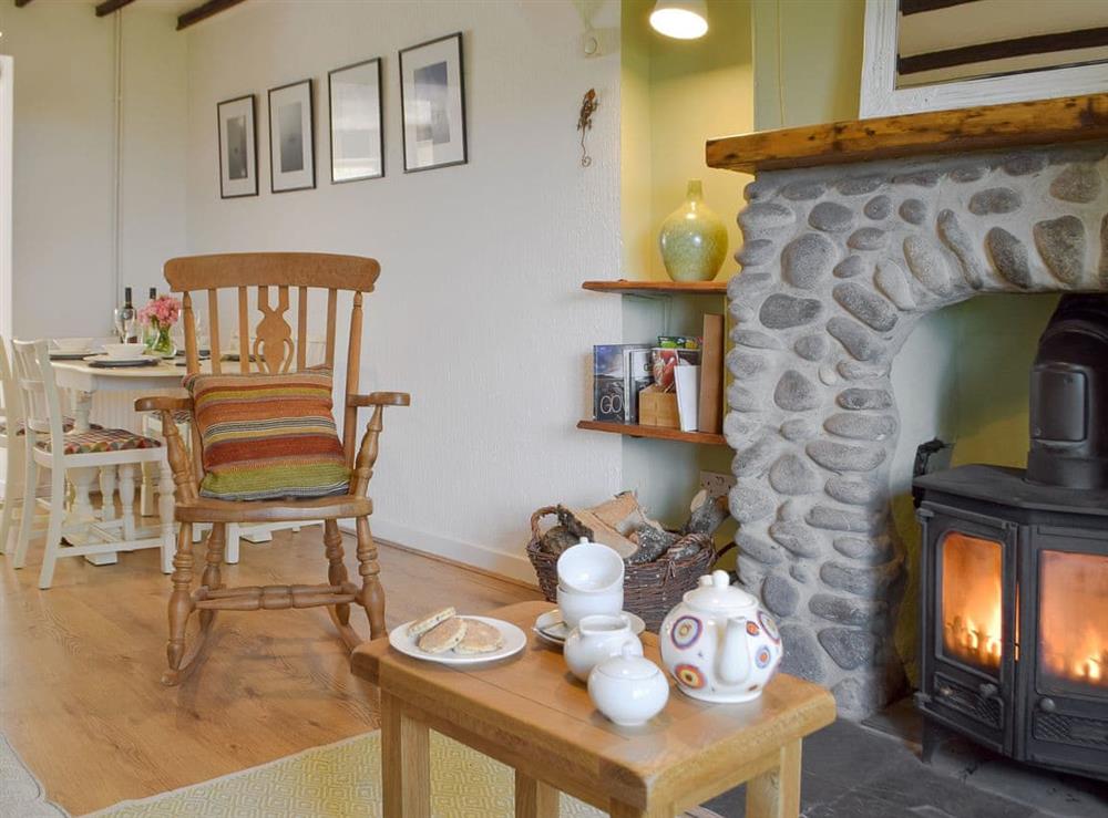 Charming living/ dining room with wood burner at Bryn Heulog in Penclawdd, near Swansea, West Glamorgan