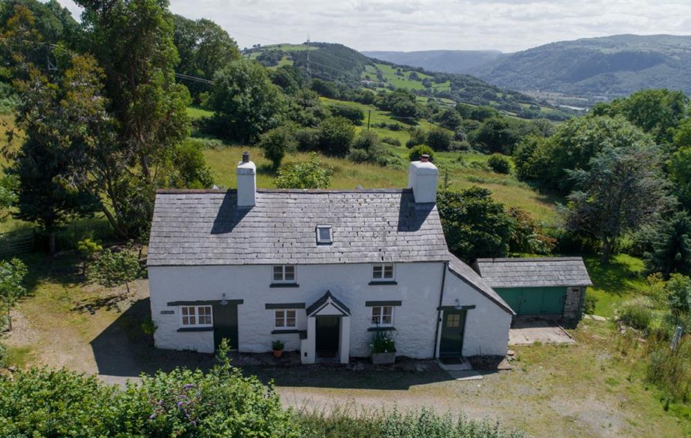Bryn Rhydd is a traditional stone cottage in an elevated position of the Bodnant Estate