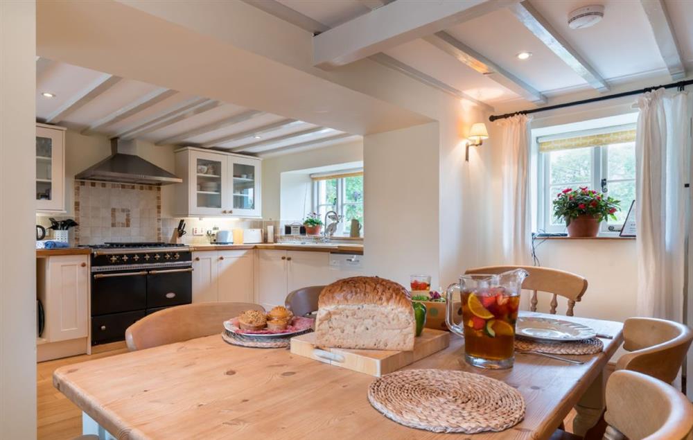 Open plan kitchen and dining table with lots of natural light at Bryn Rhydd, Bodnant Estate