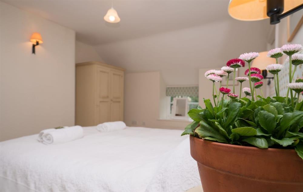 The comfortable double bedroom with king size 5’ bed (photo 2) at Bryn Rhydd, Bodnant Estate