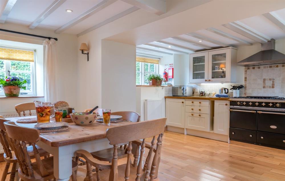 The spacious open plan kitchen and dining table at Bryn Rhydd, Bodnant Estate