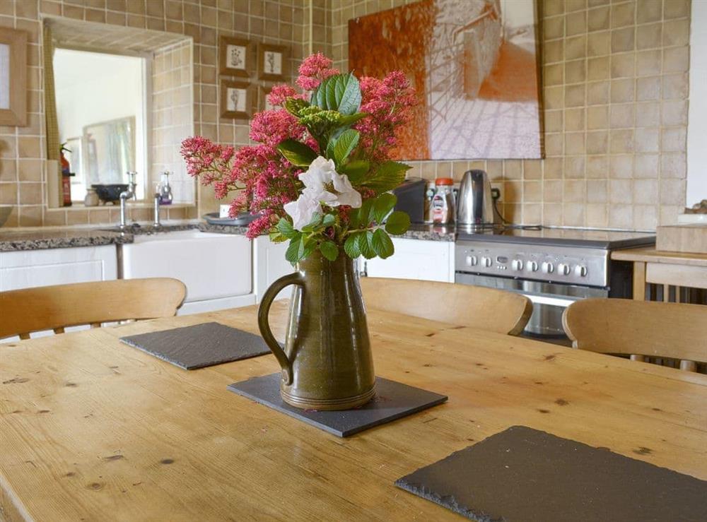 Well-equipped kitchen with dining area at Bryn Tirion in Trefor, Anglesey, Gwynedd
