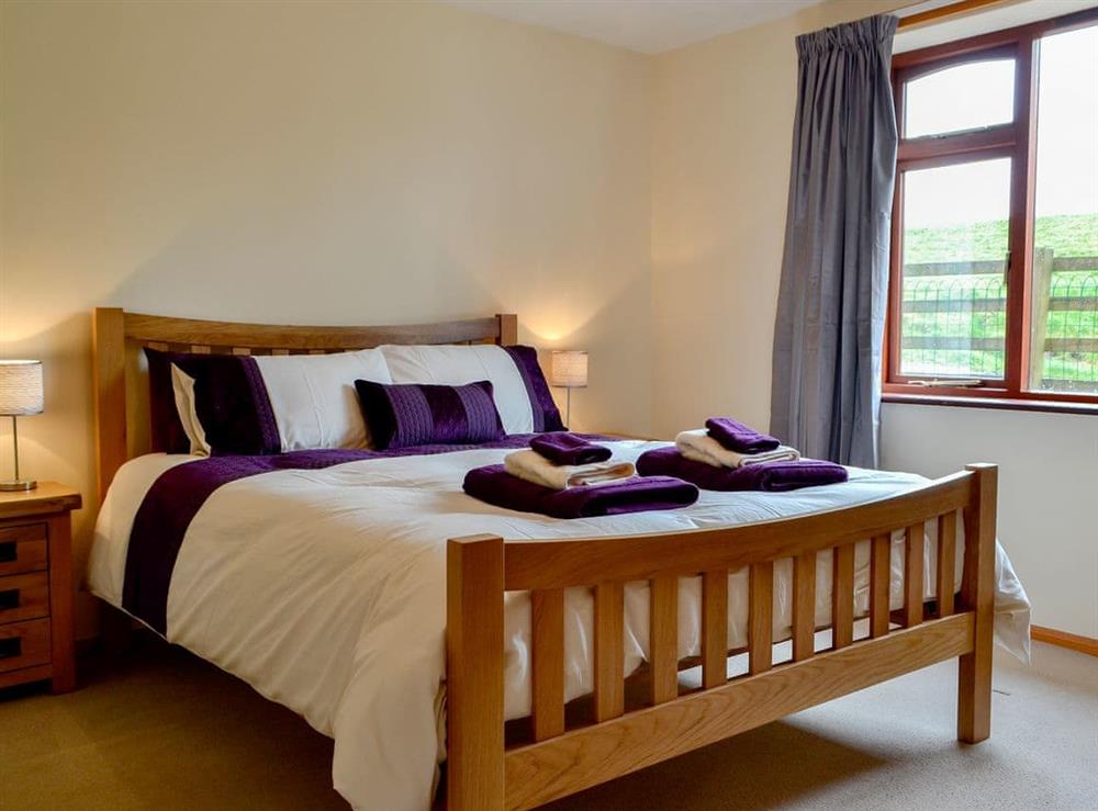 Comfortable bedroom with kingsize bed at Bryn Villa in Howey, near Llandrindod Wells, Powys