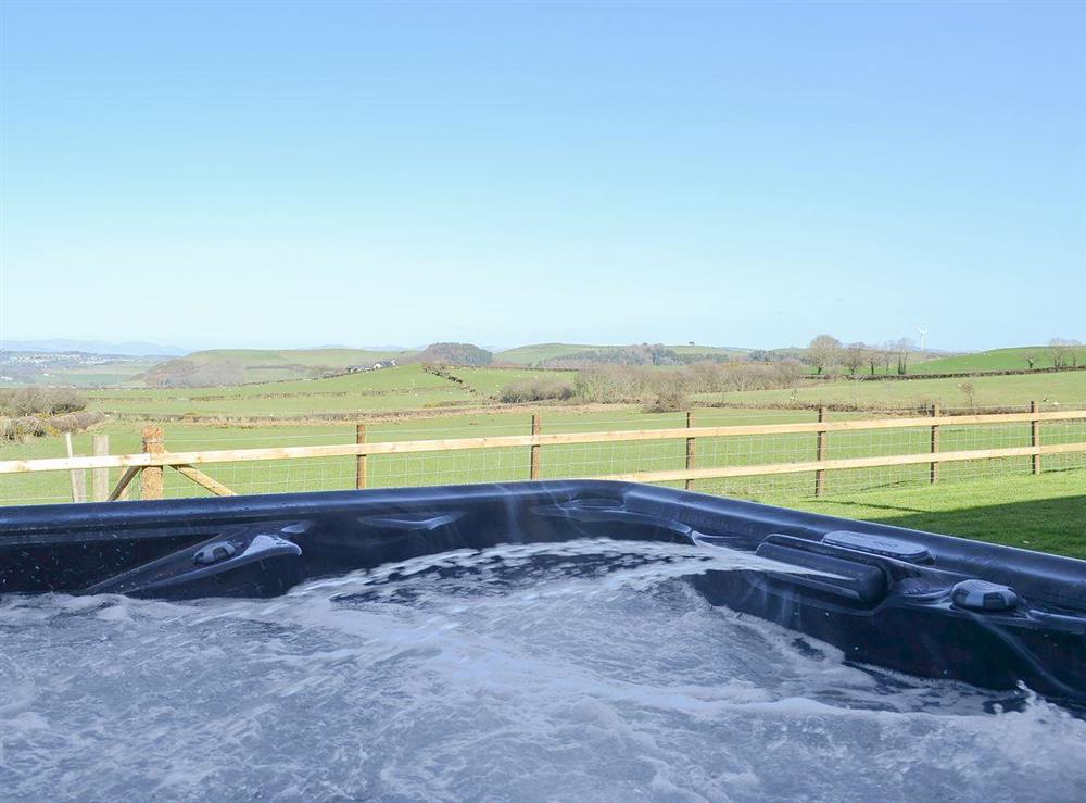 Soak up the glorious Welsh sunshine whilst relaxing in the hot tub at Bryncrwn Cottage in Llanfarian, Aberystwyth., Dyfed