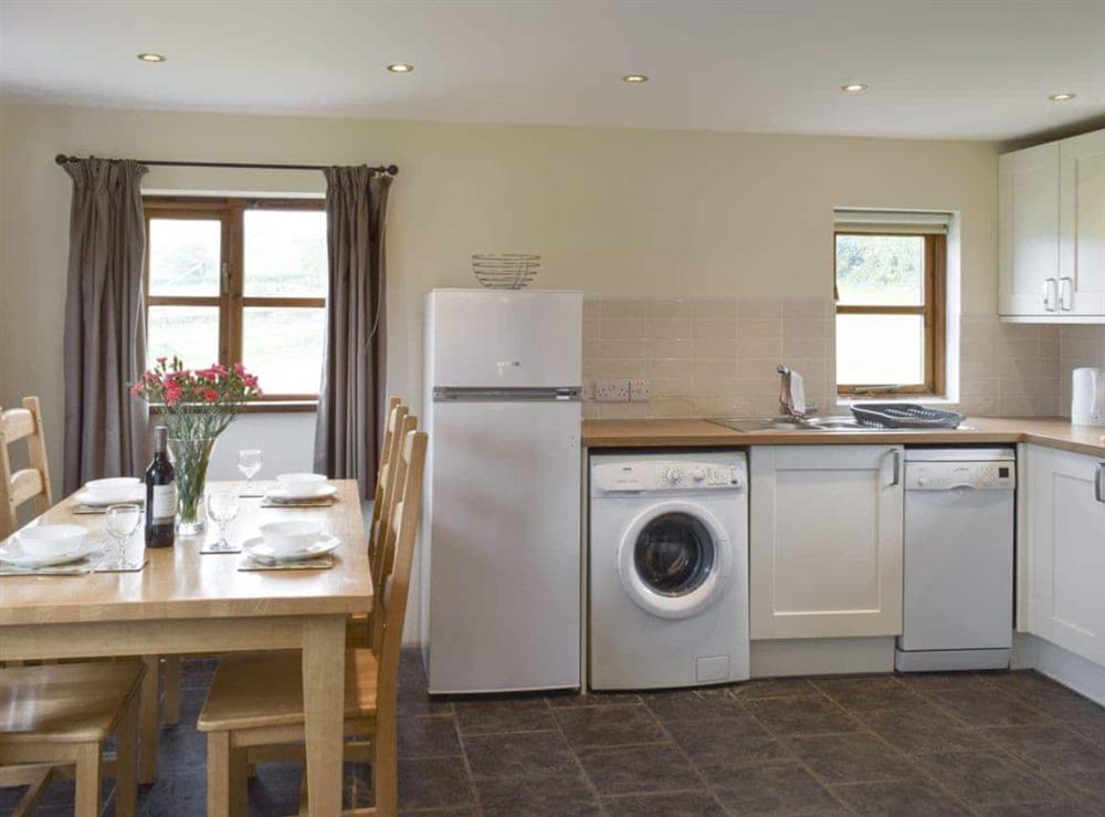Well-equipped kitchen with dining area at Bryncrwn Cottage in Llanfarian, Aberystwyth., Dyfed