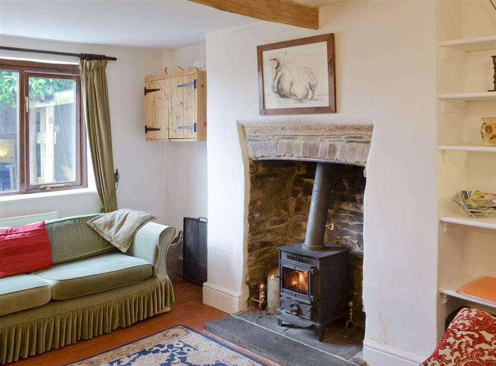 Charming lounge with wood burning stove and exposed wooden ceiling beams at Brynhoreb in Aberystwyth, Dyfed