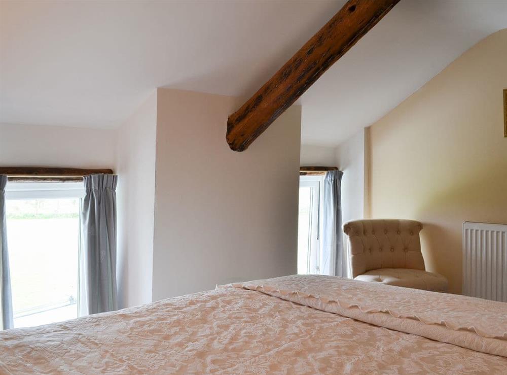 Warm and welcoming beamed double bedroom at Bryntrisant in Devil’s Bridge, near Aberystwyth, Dyfed