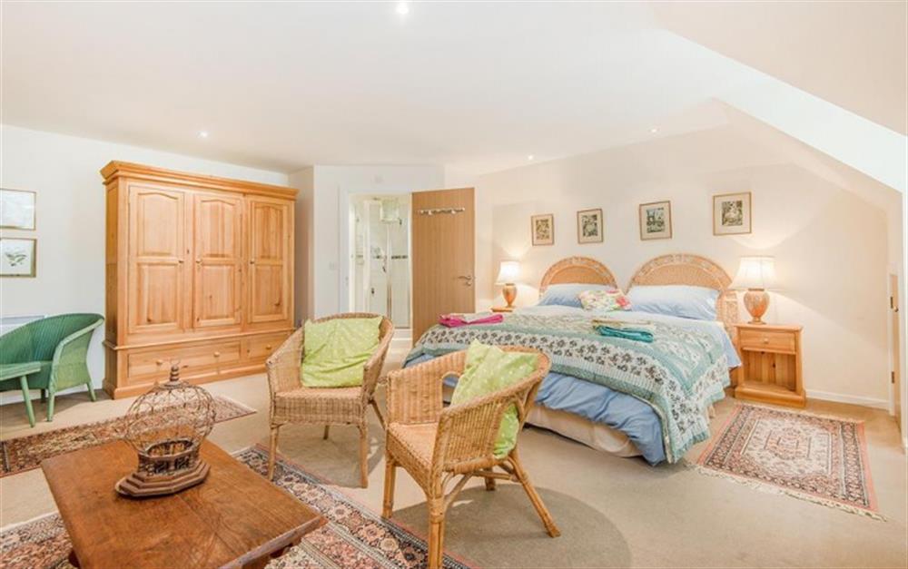 The spacious master bedroom has a sitting area at Buckfield Penthouse in Lyme Regis