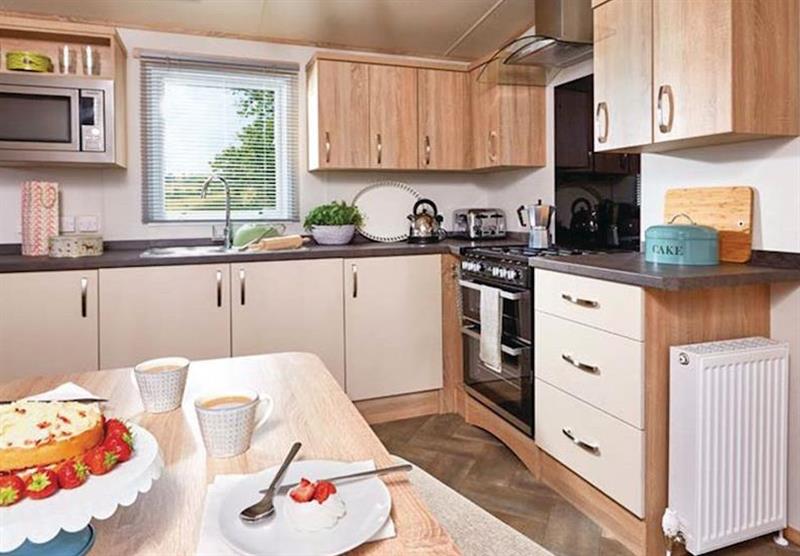 Kitchen and dining area in a typical Luxury caravan at Bucklegrove Holiday Park in Cheddar, Somerset
