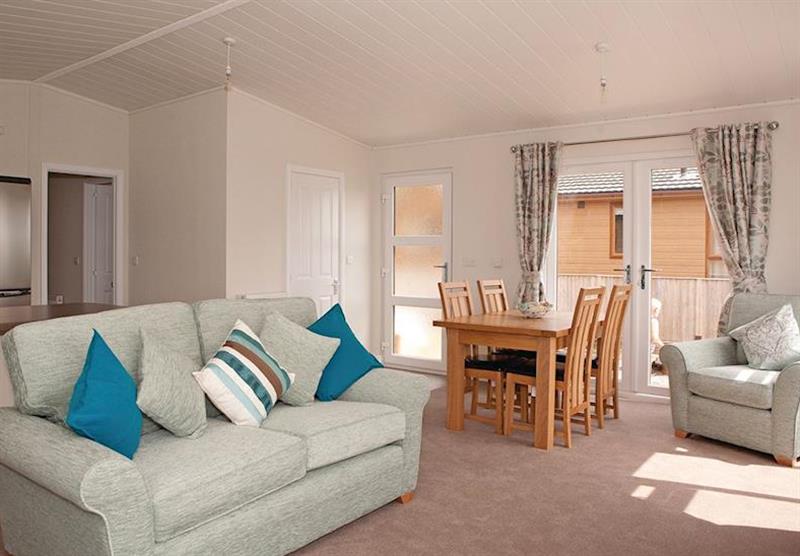 Living and dining area in a Lodge 2 at Bucklegrove Holiday Park in Cheddar, Somerset