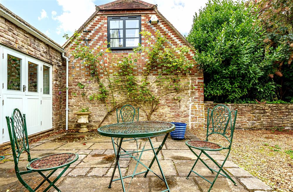A bistro set sits at the front of the property, ideal for a quiet morning coffee at Bucknowle Lodge, Wareham