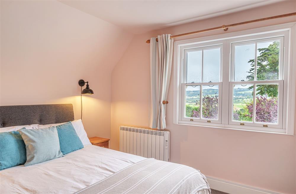 Beautiful views across the garden and countryside from the bedroom window at Bucknowle Lodge, Wareham