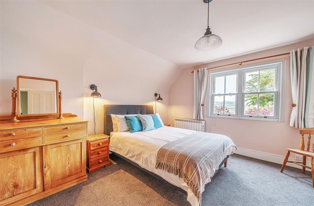 Bedroom three with a 5’ king-size bed at Bucknowle Lodge, Wareham