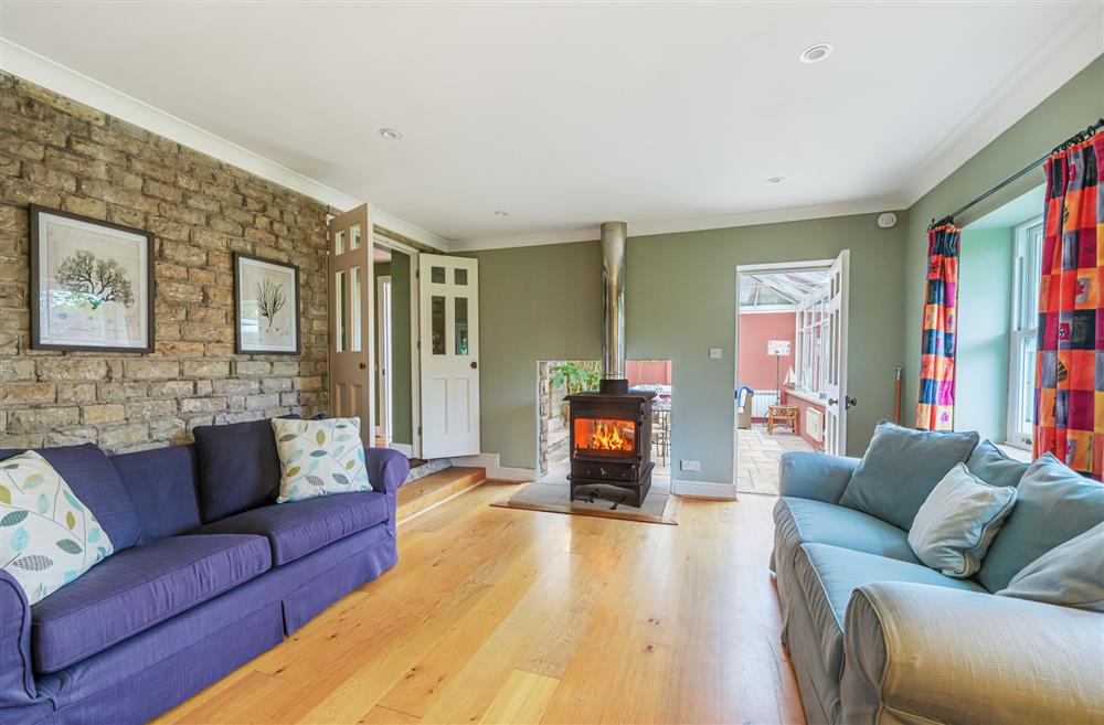 The family snug with double-sided wood burning stove at Bucknowle Lodge, Wareham