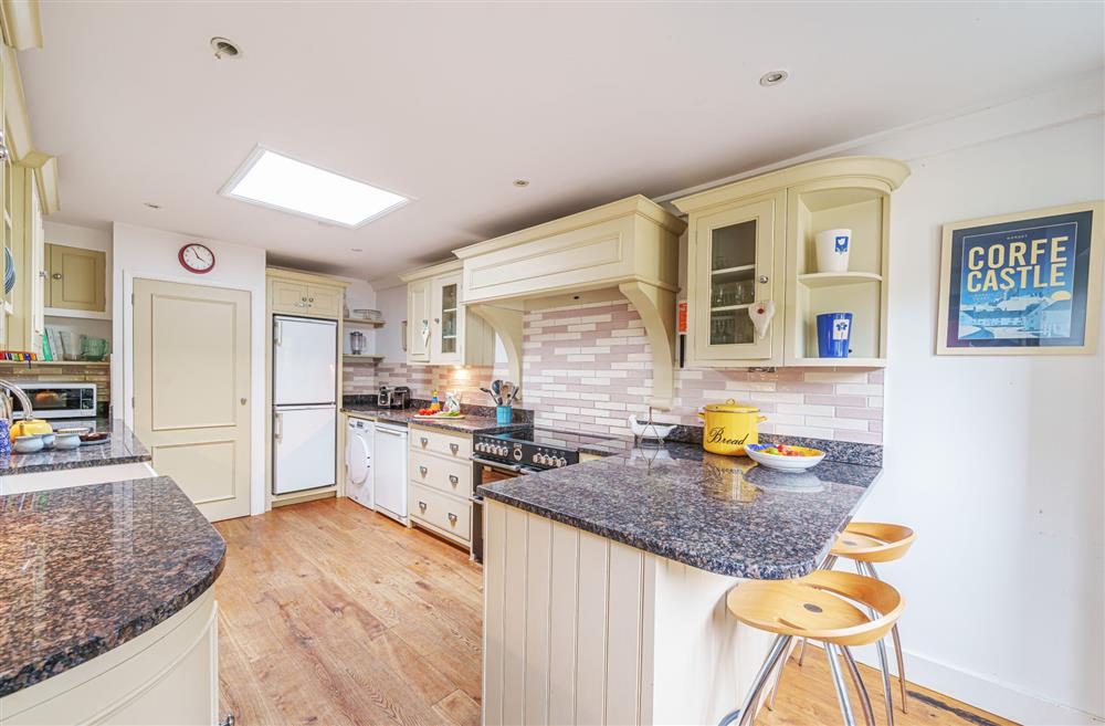 The kitchen with breakfast bar and stools at Bucknowle Lodge, Wareham
