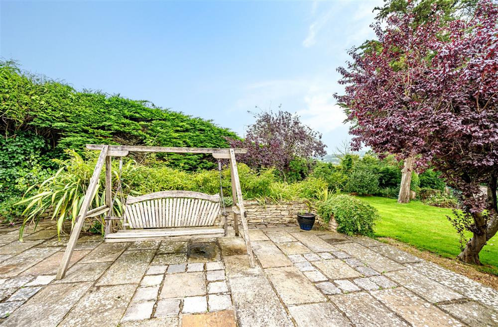 The swing seat sits on the garden terrace at Bucknowle Lodge, Wareham