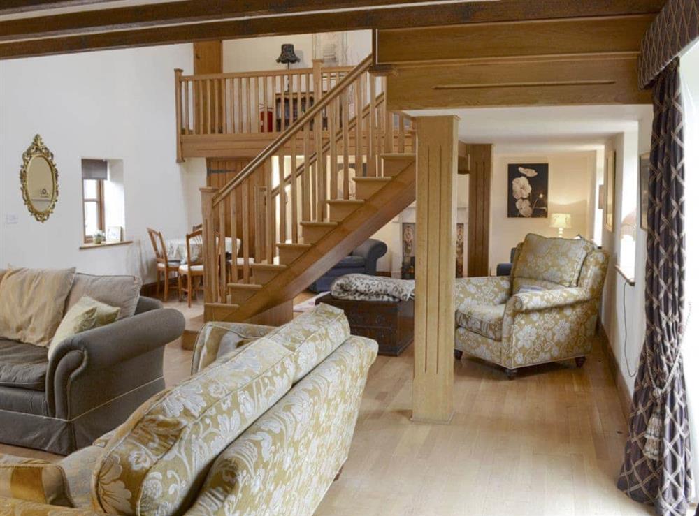 Characterful beamed ceiling and open wooden staircase at Buddileigh Farm in Betley, near Crewe, Cheshire