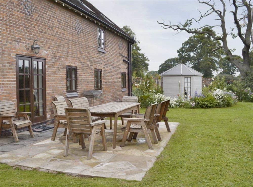 Paved patio with outdoor furniture in garden at Buddileigh Farm in Betley, near Crewe, Cheshire