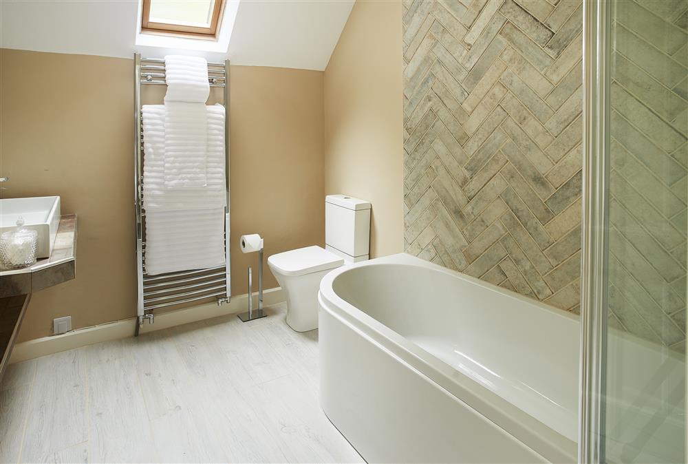 Full length bath with shower over at Bull Hollow Cottage, Shrewsbury