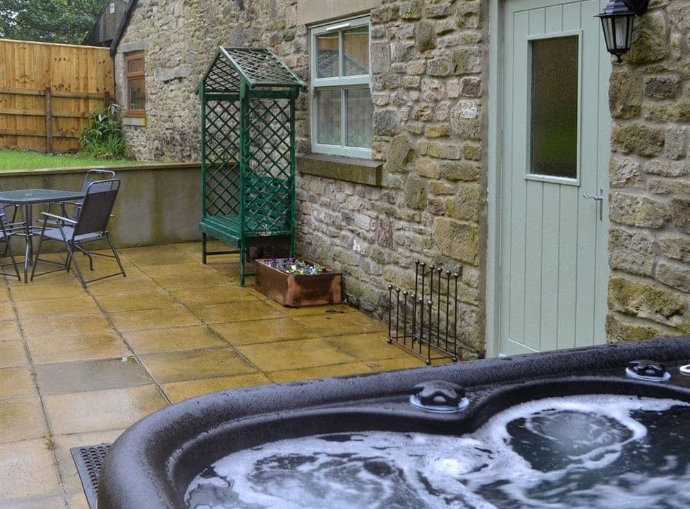 Delightful private hot tub on the paved patio area at Bullions Farm Cottage in Consett, County Durham, Northumberland