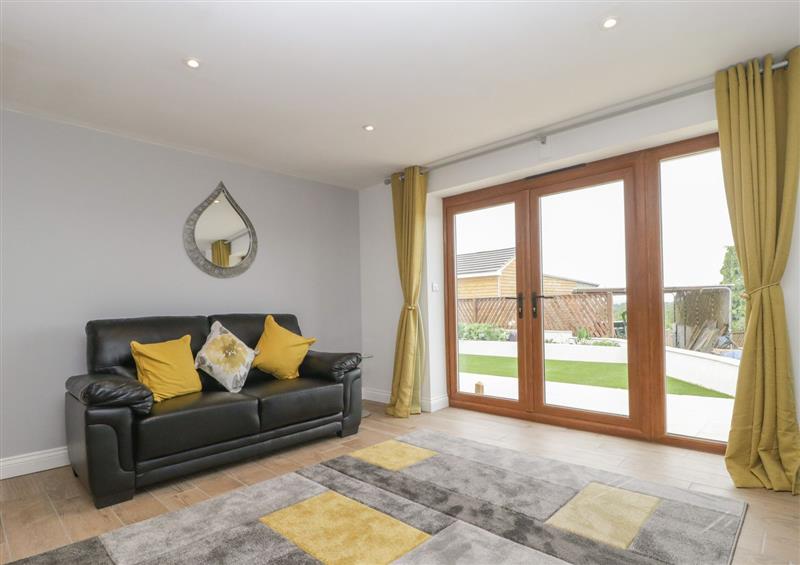 Relax in the living area at Bumble Bee Retreat, Tytherleigh