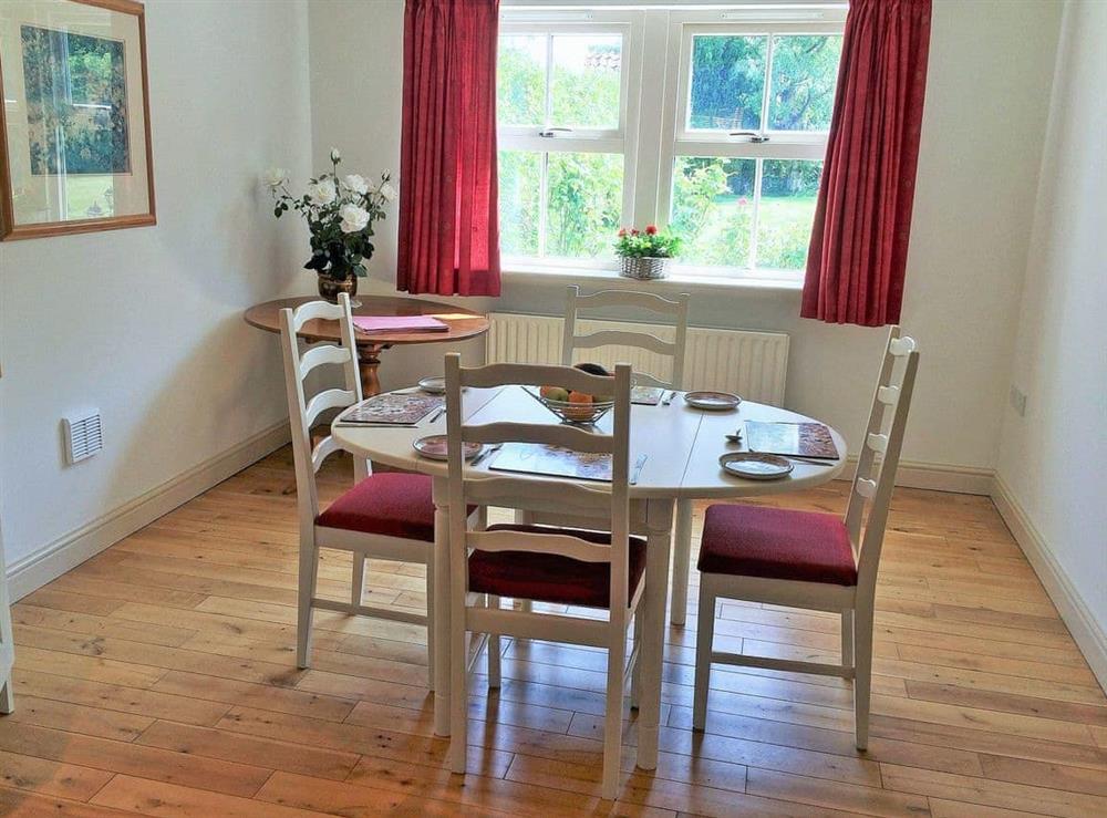 Convenient dining area adjacent to the kitchen at Bumble Cottage in Newton-on-the-Moor, Northumberland., Great Britain