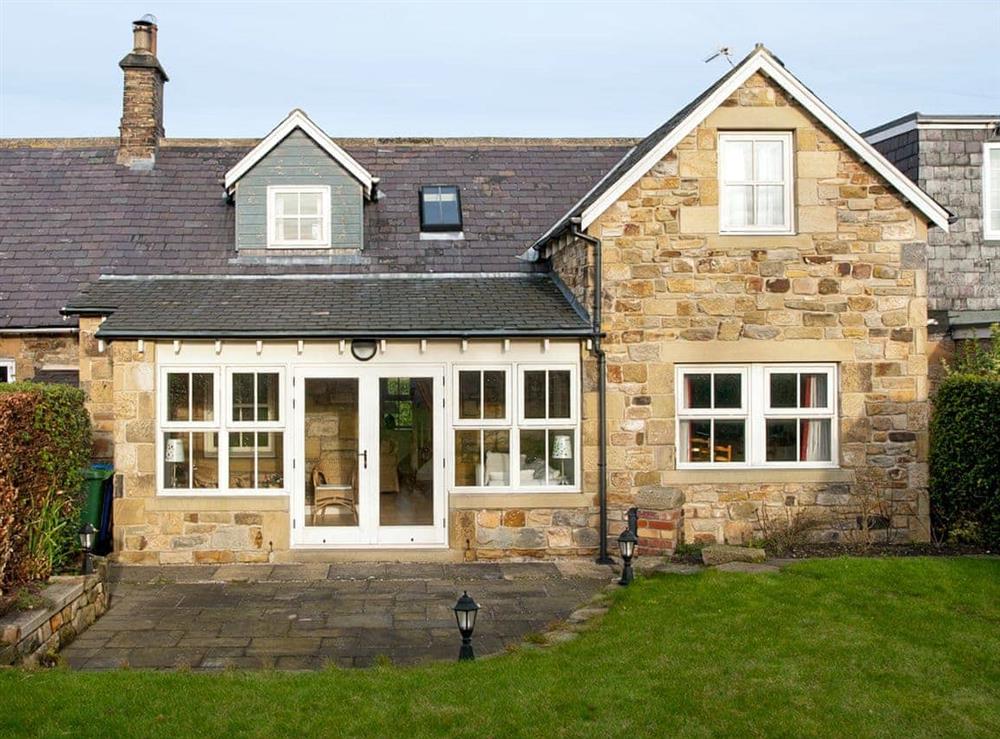 Garden showing large patio at Bumble Cottage in Newton-on-the-Moor, Northumberland., Great Britain