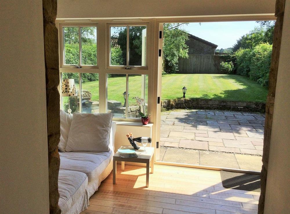 View from the living area through to the garden at Bumble Cottage in Newton-on-the-Moor, Northumberland., Great Britain