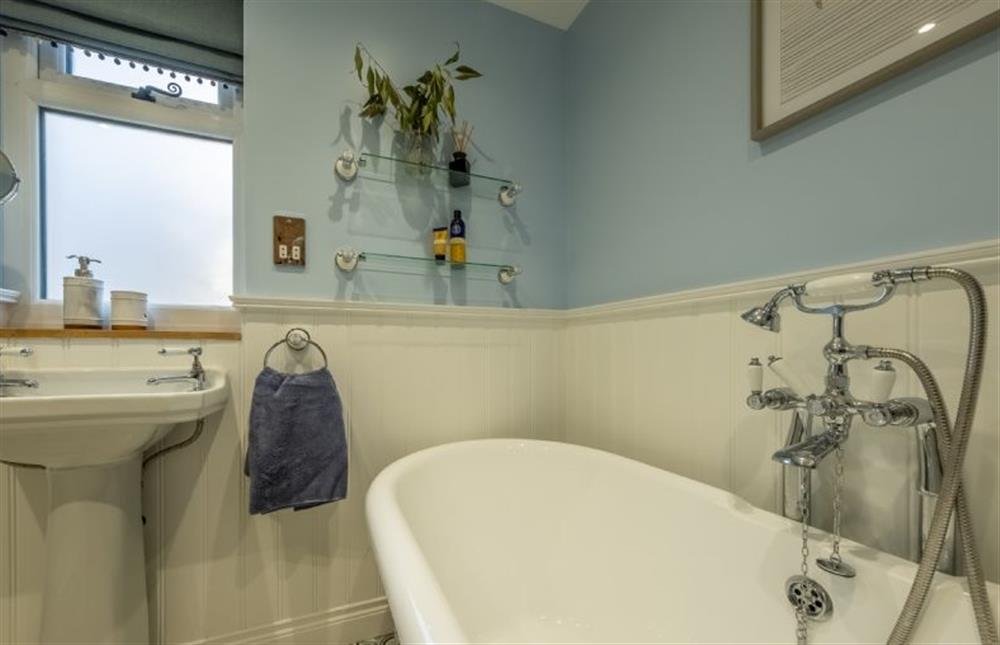The bathroom has roll-top bath with hand-held shower as well as separate shower cubicle at Bumblebee Cottage, Culford Heath near Bury Saint Edmunds