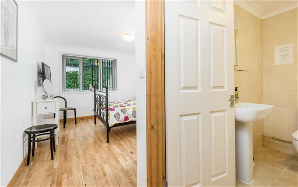 Double bedroom showing bathroom entrance at Burgate House Lodge in Fordingbridge