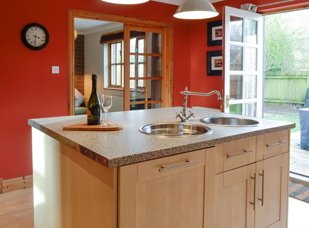Spacious kitchen with French doors to garden at Burnbrae Cottage in Bridgend of Lintrathen, near Forfar, Angus