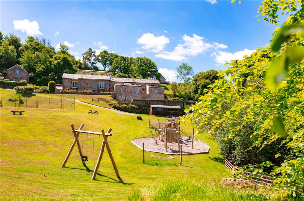 The children’s outdoor play ground with traditional wooden seats at Burrator Cottage, Dartmouth