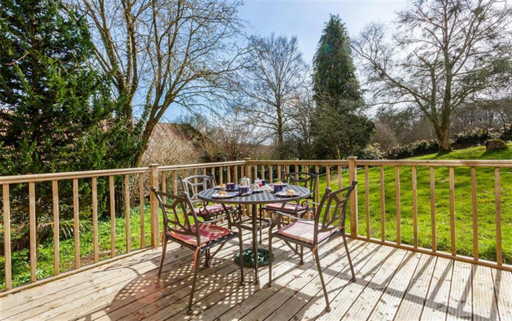 French doors from the lounge lead to the deck area and garden  at Burrow Hill Cottage in Honiton