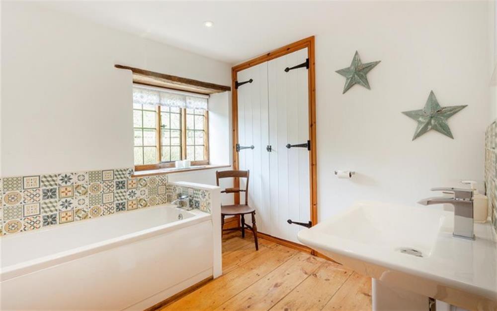 Large family bathroom with bath, hand basin, w.c. and heated towel rail.   at Burrow Hill Cottage in Honiton
