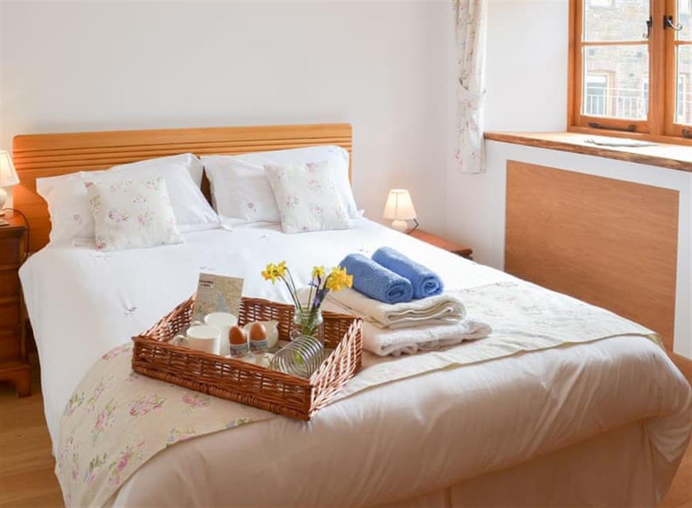 Welcoming bedroom with double bed at The Hayloft, 