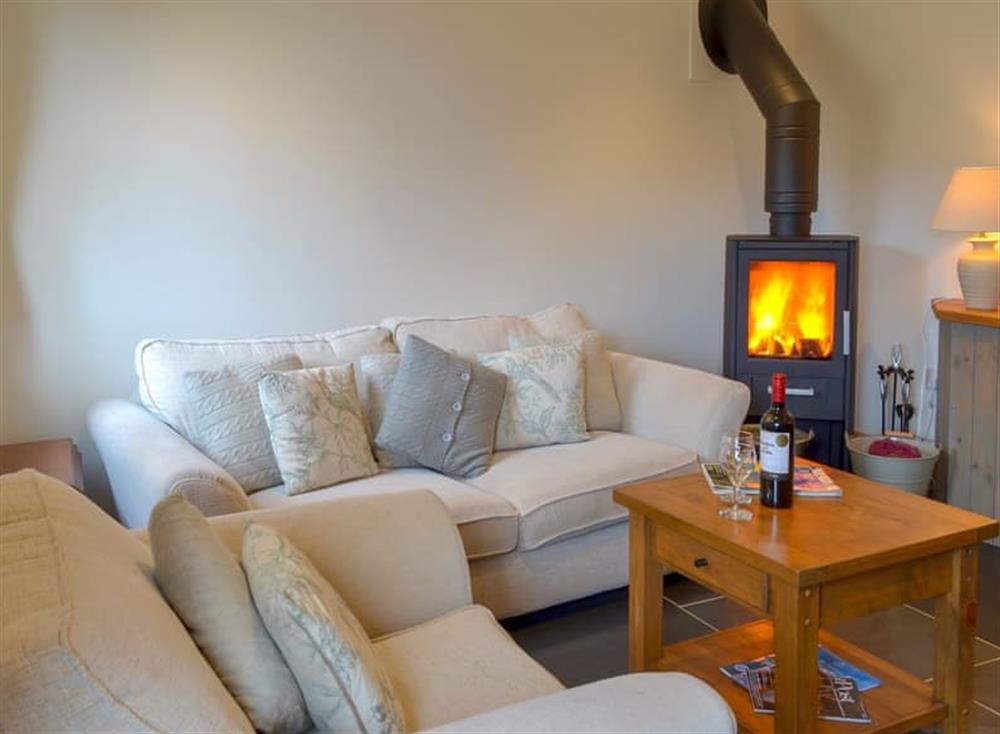 Cosy living area with wood burner at The Piggery, 