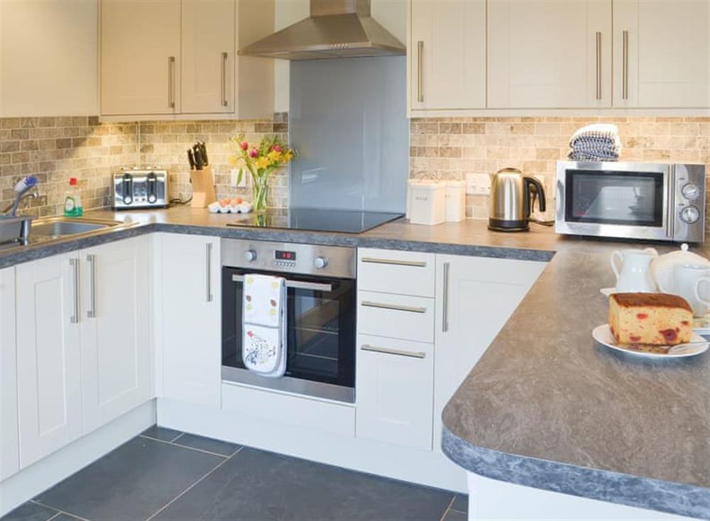 Delightful kitchen with breakfast bar at The Stables, 