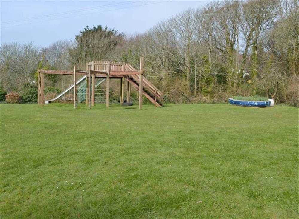 Recreation area with children’s play equipment at The Stables, 