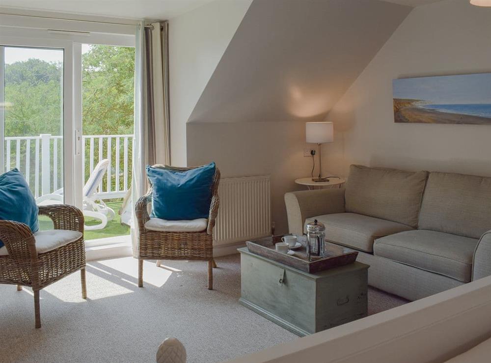 Spacious master bedroom with seating area and balcony at Burwyns in Ventnor, Isle of Wight