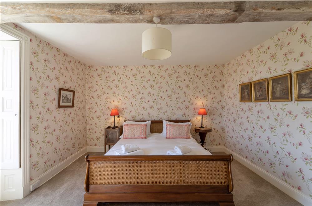 Beautiful wallpaper adorns this bedroom at Butley Priory Farmhouse, Woodbridge