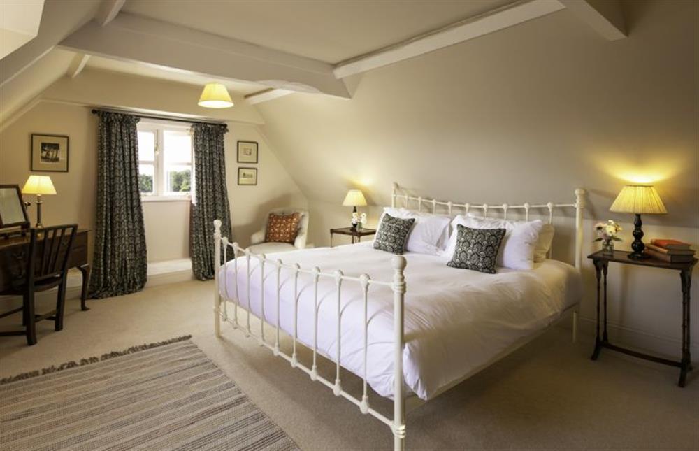 Each bedroom has clothes storage, bedside tables and lamps at Butley Priory Farmhouse, Woodbridge