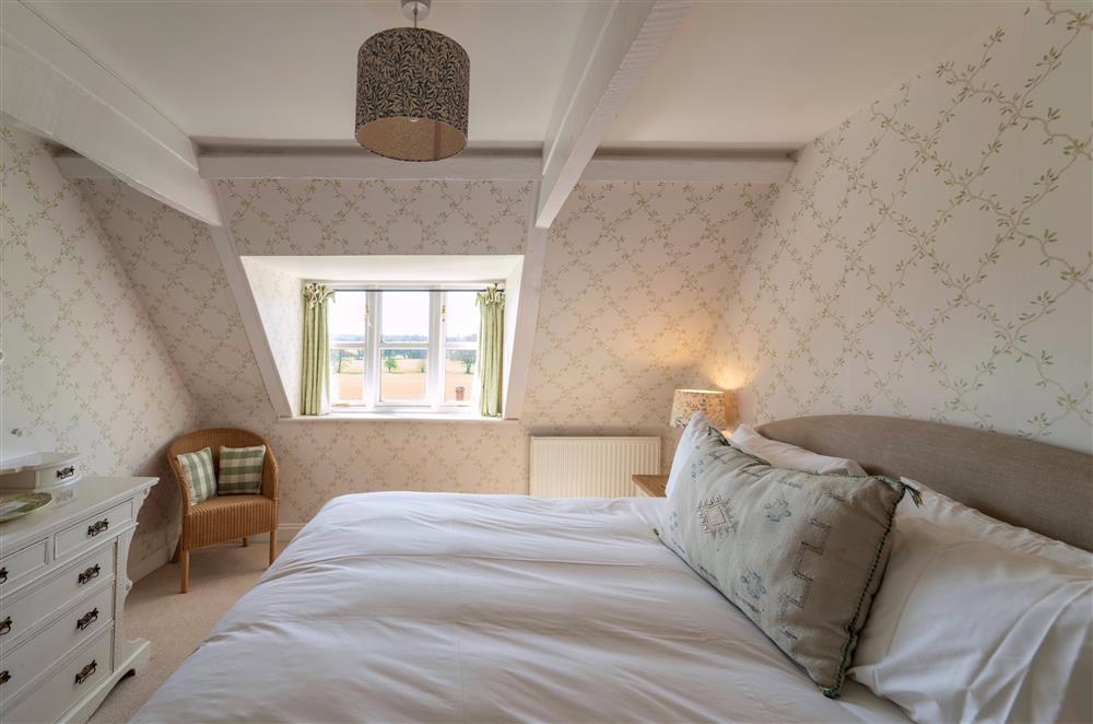 Large bedrooms with views of the surrounding land at Butley Priory Farmhouse, Woodbridge