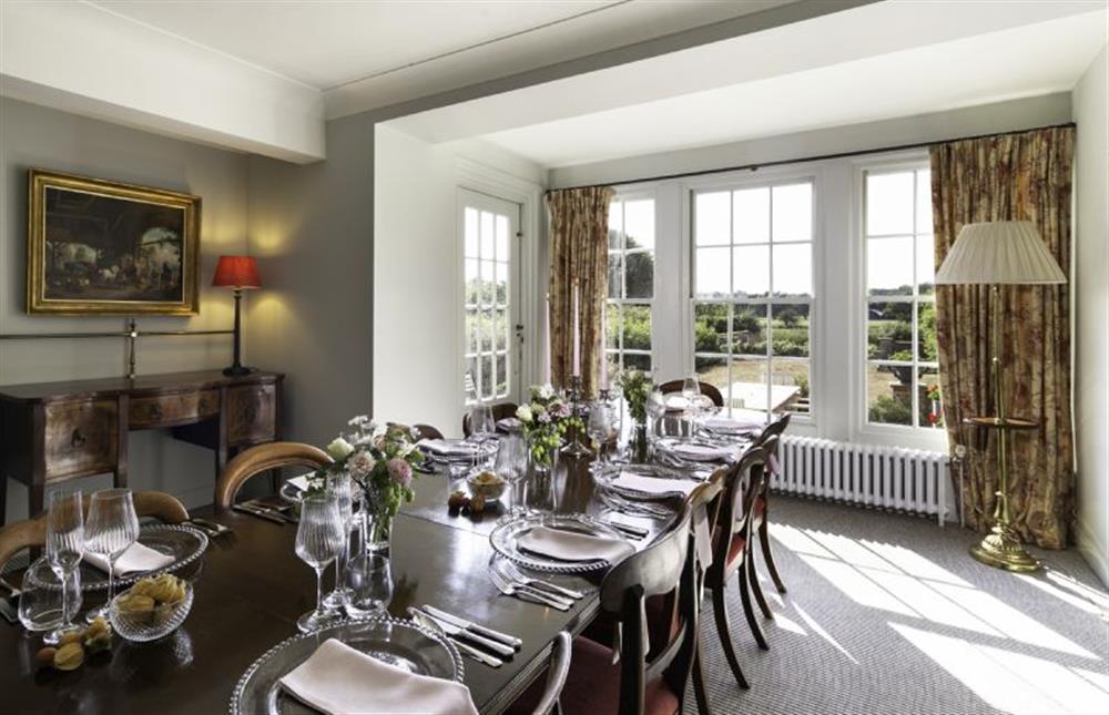 The dining table with fantastic views over the surrounding land at Butley Priory Farmhouse, Woodbridge