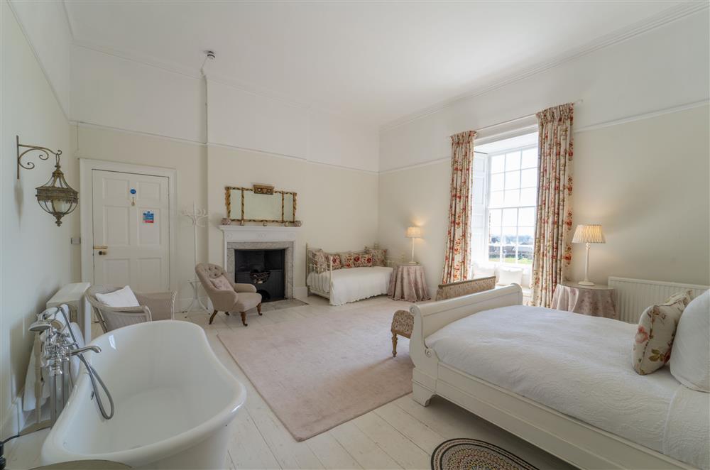 Free standing bath, comfortable seating and large, luxuriously comfortable beds  at Butley Priory, Woodbridge